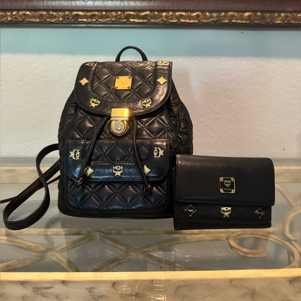 Authentic MCM Black Quilted Backpack with Gold Details and Matching Wallet.